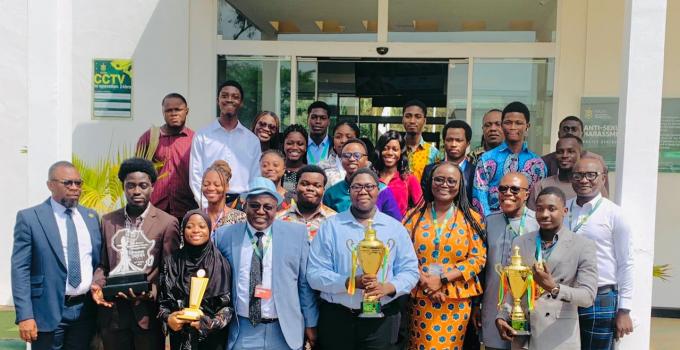 Members of the KNUST Debate Society with their trophies in a group photo with the Vica Chancellor, Professor Mrs. Rita Akosua Dickson (Front row,  fourth from right), the Vice Chancellor, Professor Ellis Owusu-Dabo (Front row, third from right) and other management members.